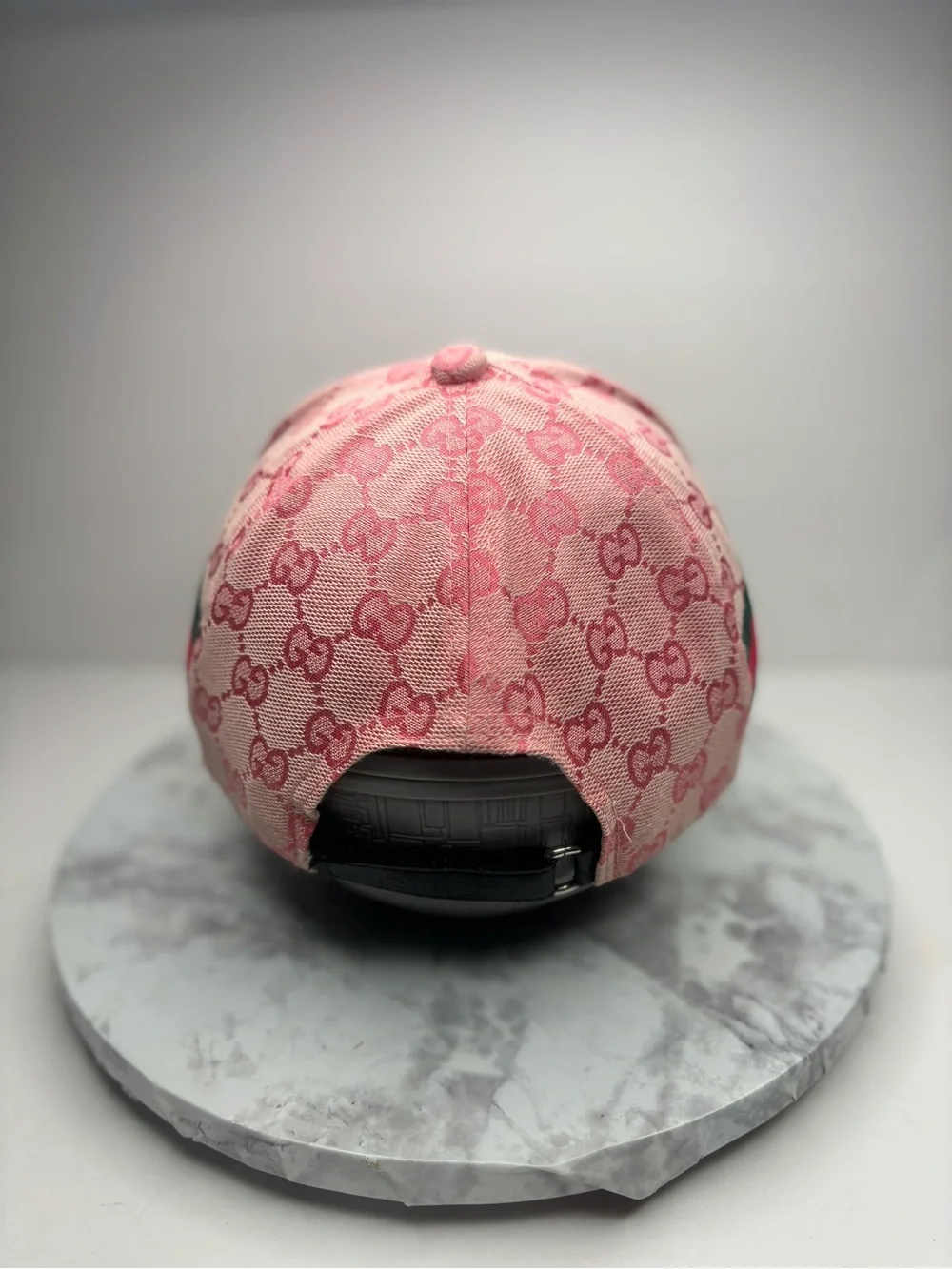 Gucci baseball cap featuring a pink GG monogram canvas and a leather patch